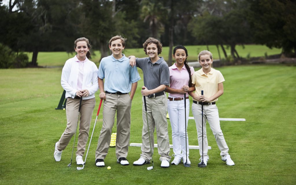 junior golfers on the driving range